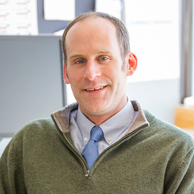 Peter Smiar in a tie and green sweater