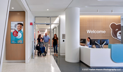 Children’s Hospital welcome room with children and parents existing after a medical visit