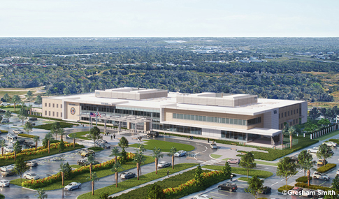 Realistic rendering of new Veteran’s clinic and adjacent parking lots nestled in a wooded site. 