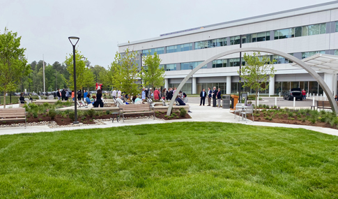 People gather in the courtyard during the Sheltering Arms Hospital ribbon cutting ceremony. 