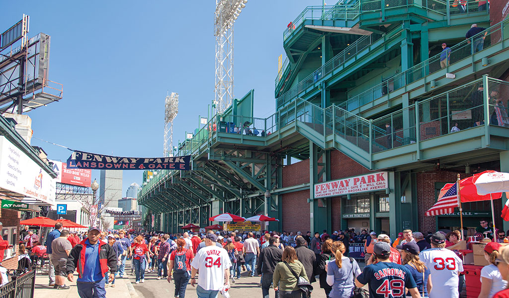 Pedestrians stroll along Lansdowne Street outside of Fenway Park in Boston.