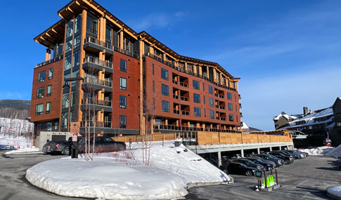 Snowy view of One Spruce Peak residences and penthouses.