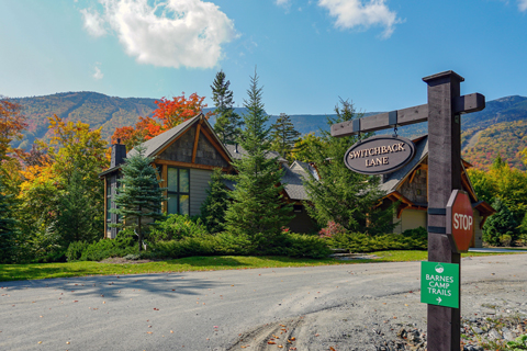 View of the winding road leading to Switchback Terrace Drive and new homes set within the mountains in fall. 