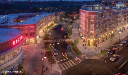 Aerial view of a curving city street at night.