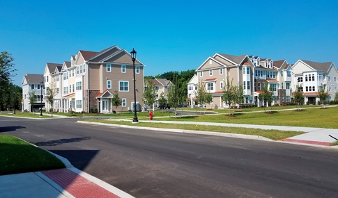 Multi-story residences surrounded by newly planted trees at The Ridge at Talcott Mountain in Simsbury, Connecticut.