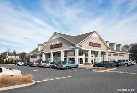 Exterior of a modern CVS/pharmacy location & parking lot.