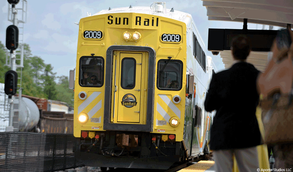 A man waits to board an incoming SunRail train.