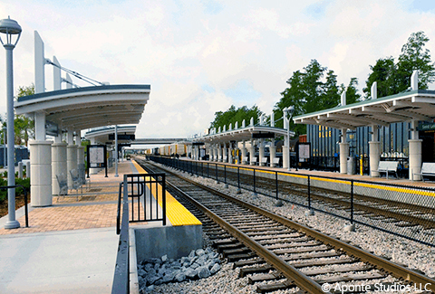 Train tracks pass in front of a SunRail station. 