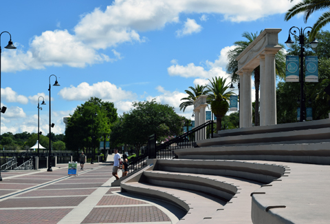 People walking down stone steps with columns.