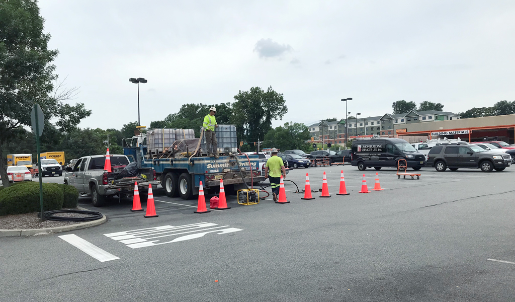 Crew at work in the parking lot of the retail center.