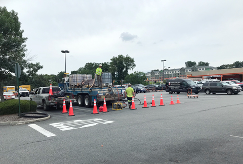 Crew at work in the parking lot of the retail center.