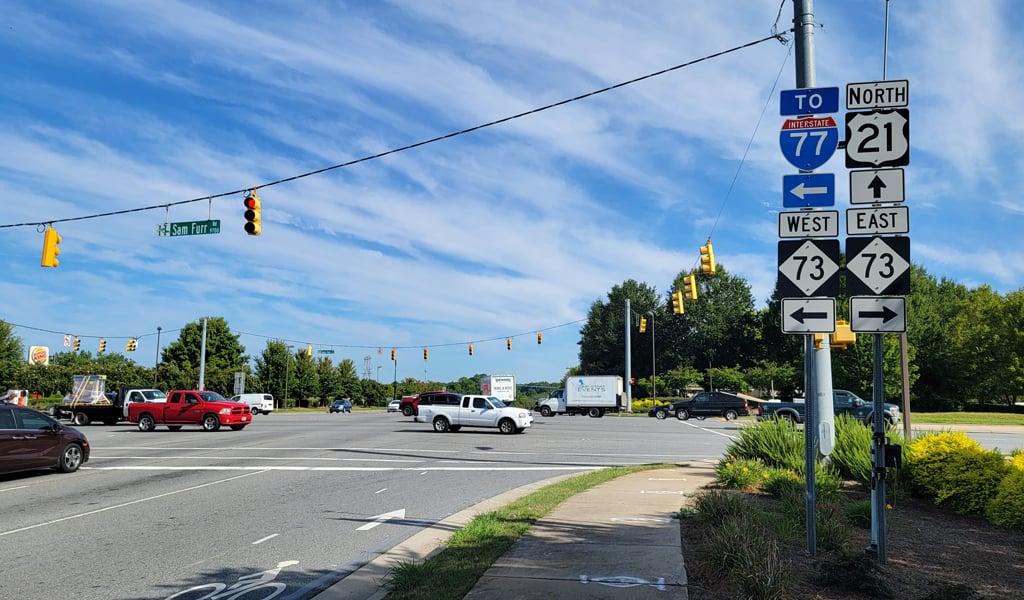 Cars moving through intersection. 