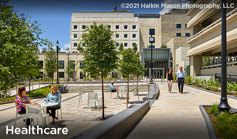 People sit and walk on the campus of Children’s National Research and Innovation Campus.