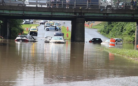 Submerged vehicles on flooded roadway.