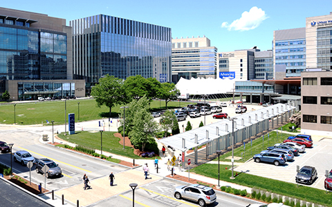 Image of UMass parking lot and pedestrians