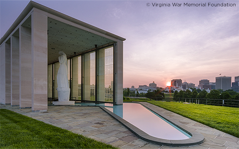 The Virginia War Memorial at sunset that showcases the view of the Richmond skyline.