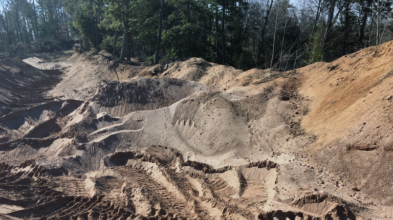 Gravel pits with a trees in the background