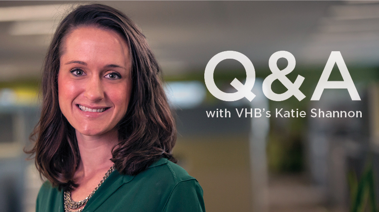 Katie Shannon wears a green shirt in an office setting.