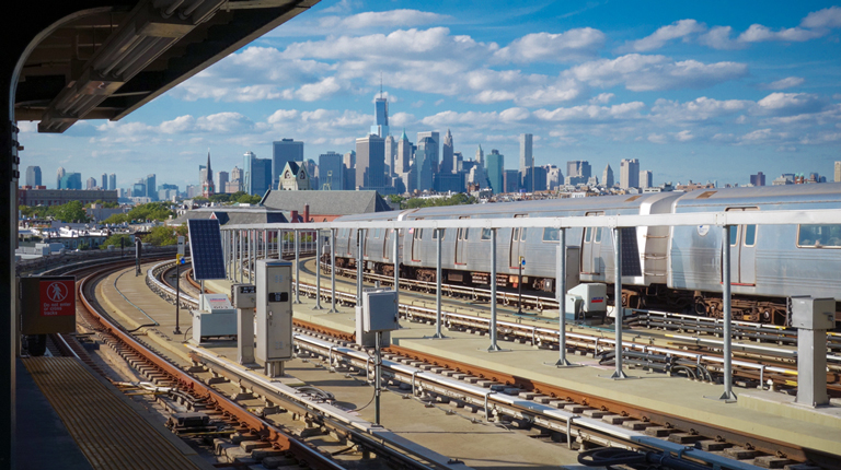 New York City subway on outside tracks during the day.