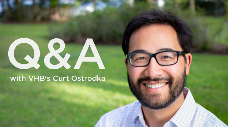 A photo Curt Ostrodka smiling and standing casually in a yard. 