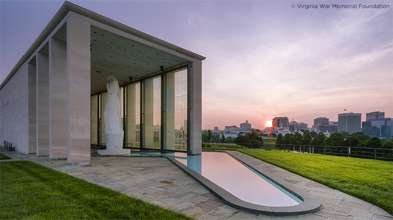 The Virginia War Memorial at sunset that showcases the view of the Richmond skyline.