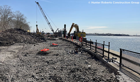 A waterfront construction site with a crane