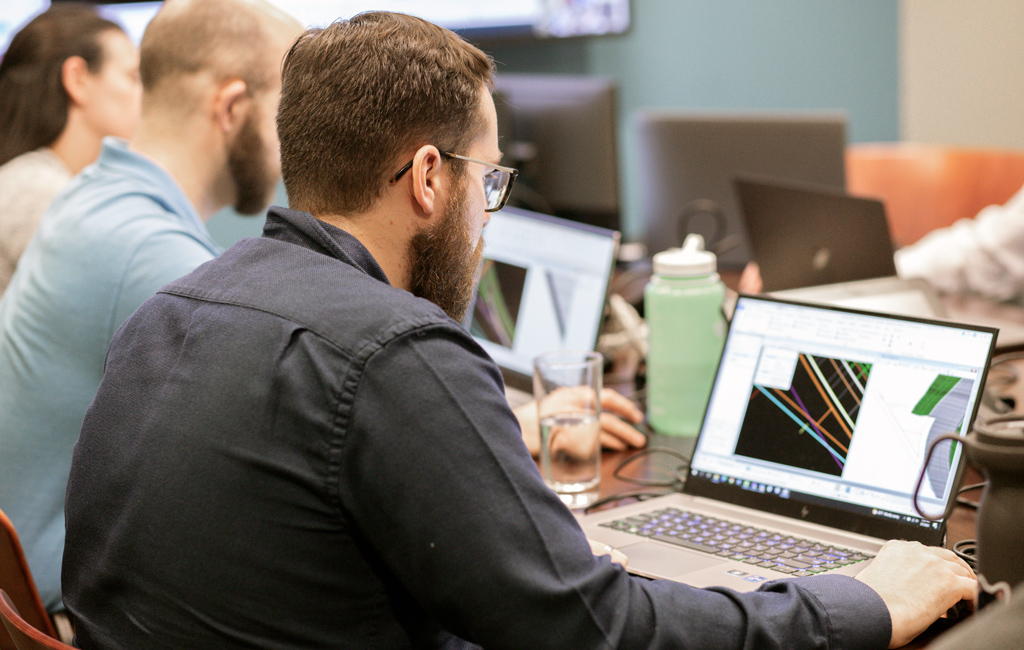 A group of trainees looking at laptop computers.