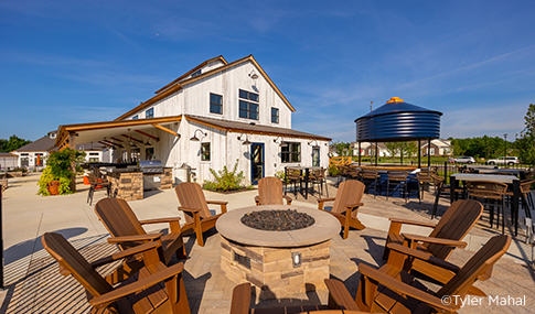 A fire pit surrounded by chairs showcases the focus on community.  