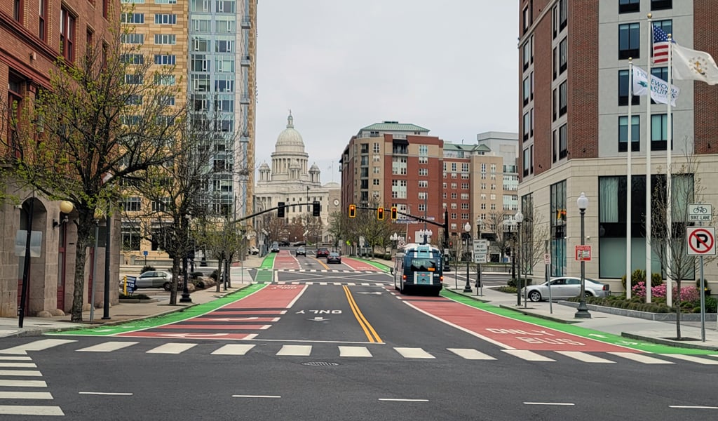 Bicycle signal faces, red colored transit lanes and green bicycle lanes in downtown Providence, Rhode Island 