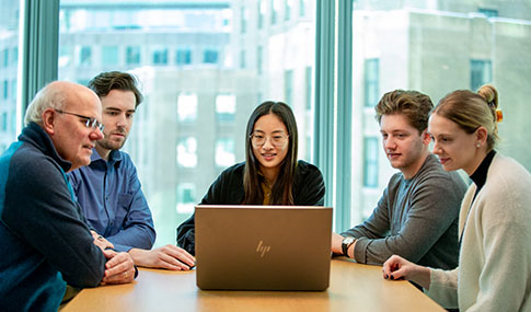 Five VHBers working at a conference table.