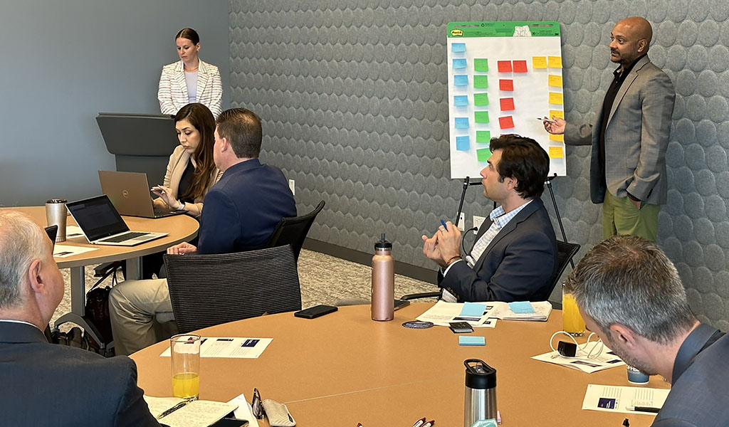 Meeting attendees taking notes during a fireside chat presentation.