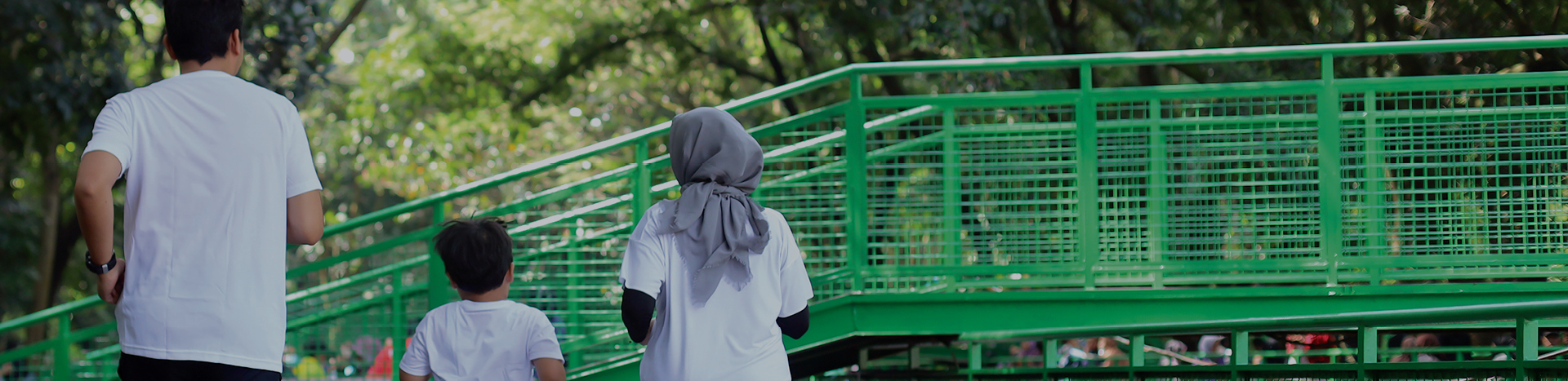 A Muslim family jogging in a park