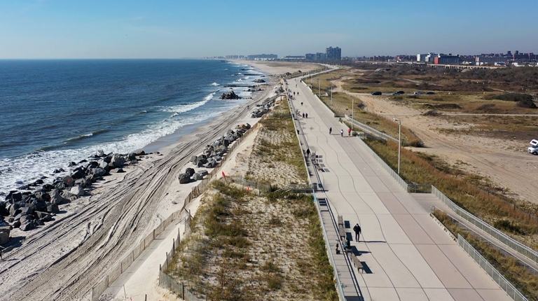 Aerial view of a beach and walkway.