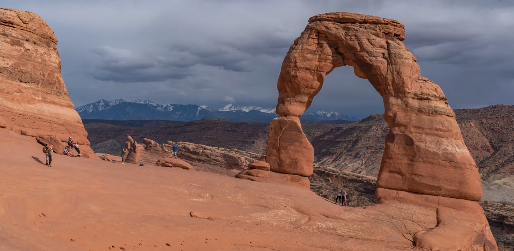 A time lapse shows visitors at the end of the hike to Delicate Arch in Arches National Park.